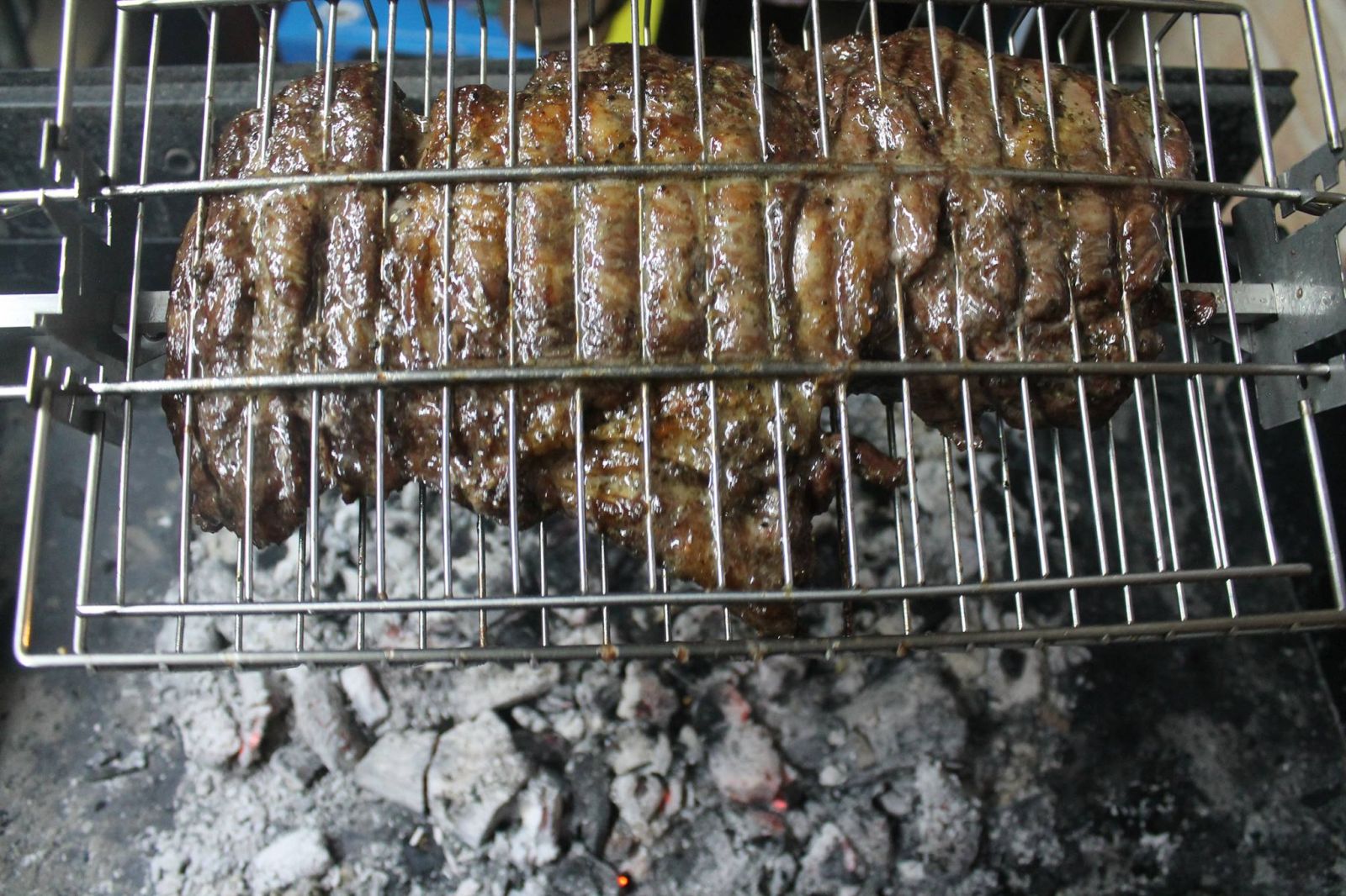 Deboned leg of lamb cooking on a Cyprus Spit Roaster